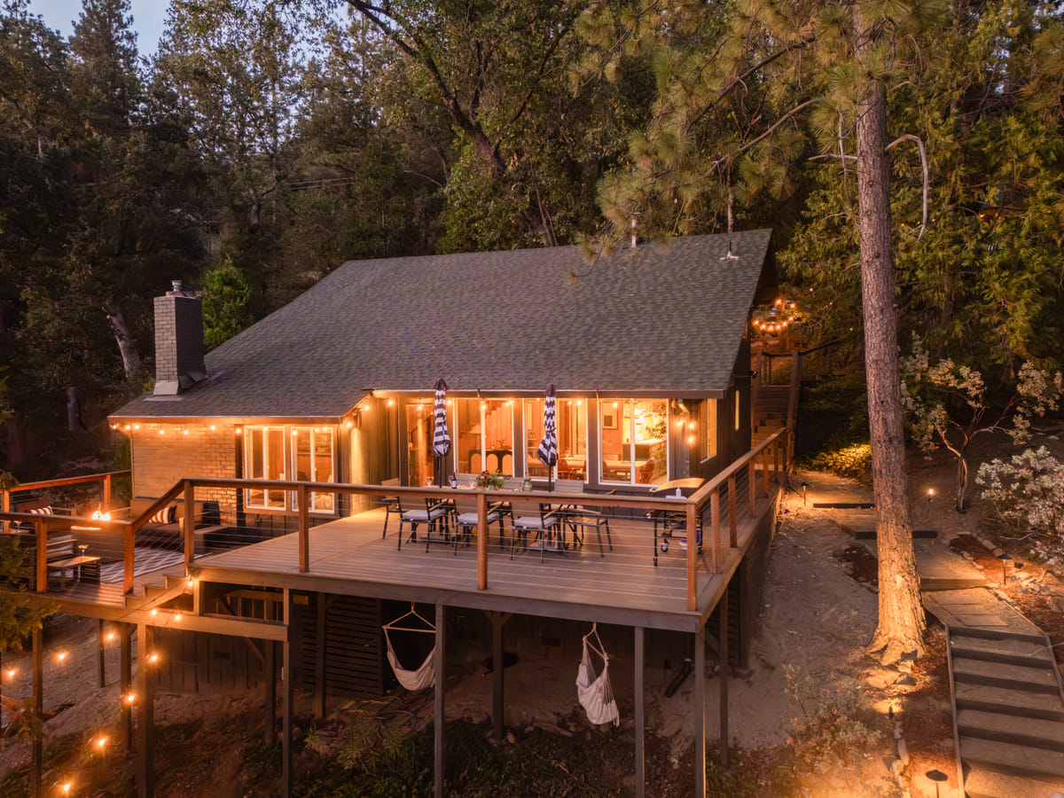 The cabin at twilight from above, every light on
