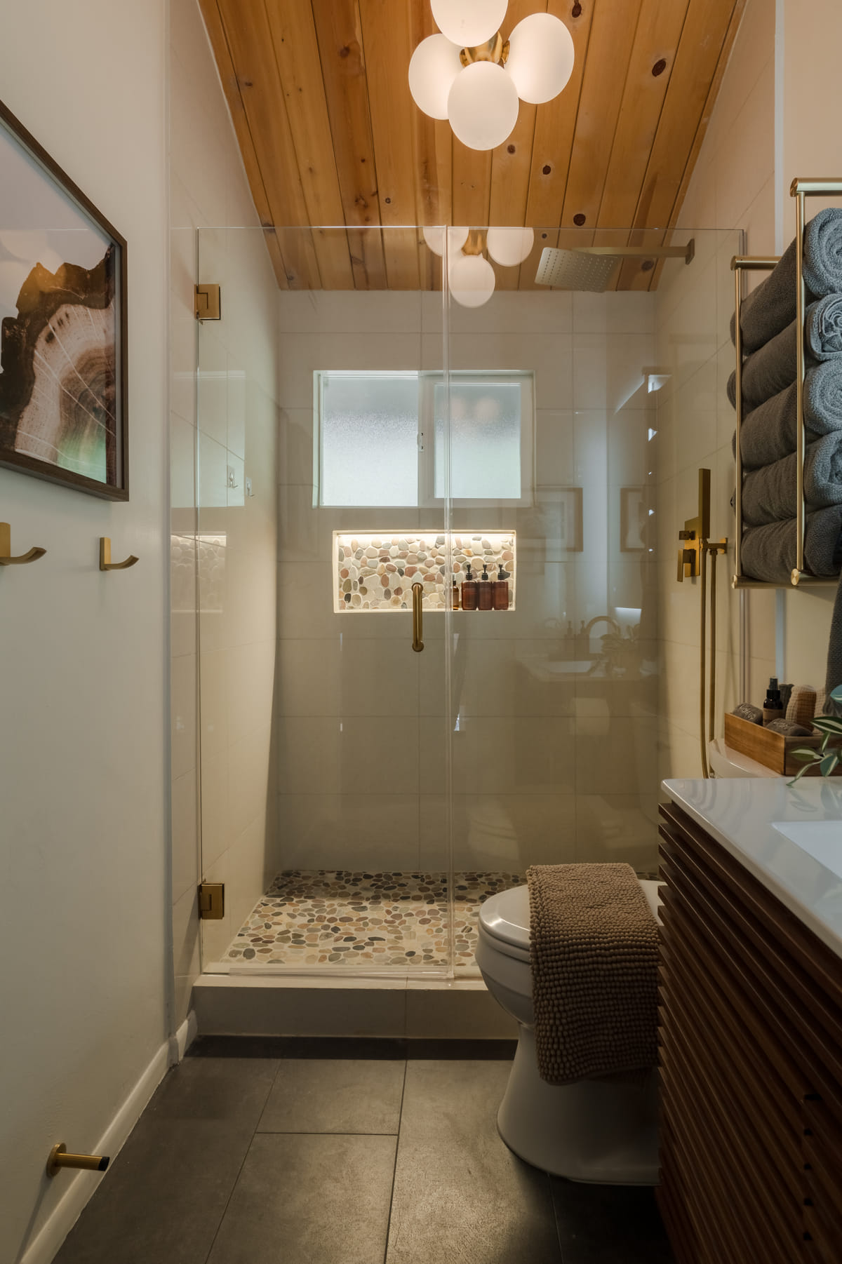 The upstairs bath, a glass shower with a pebble floor