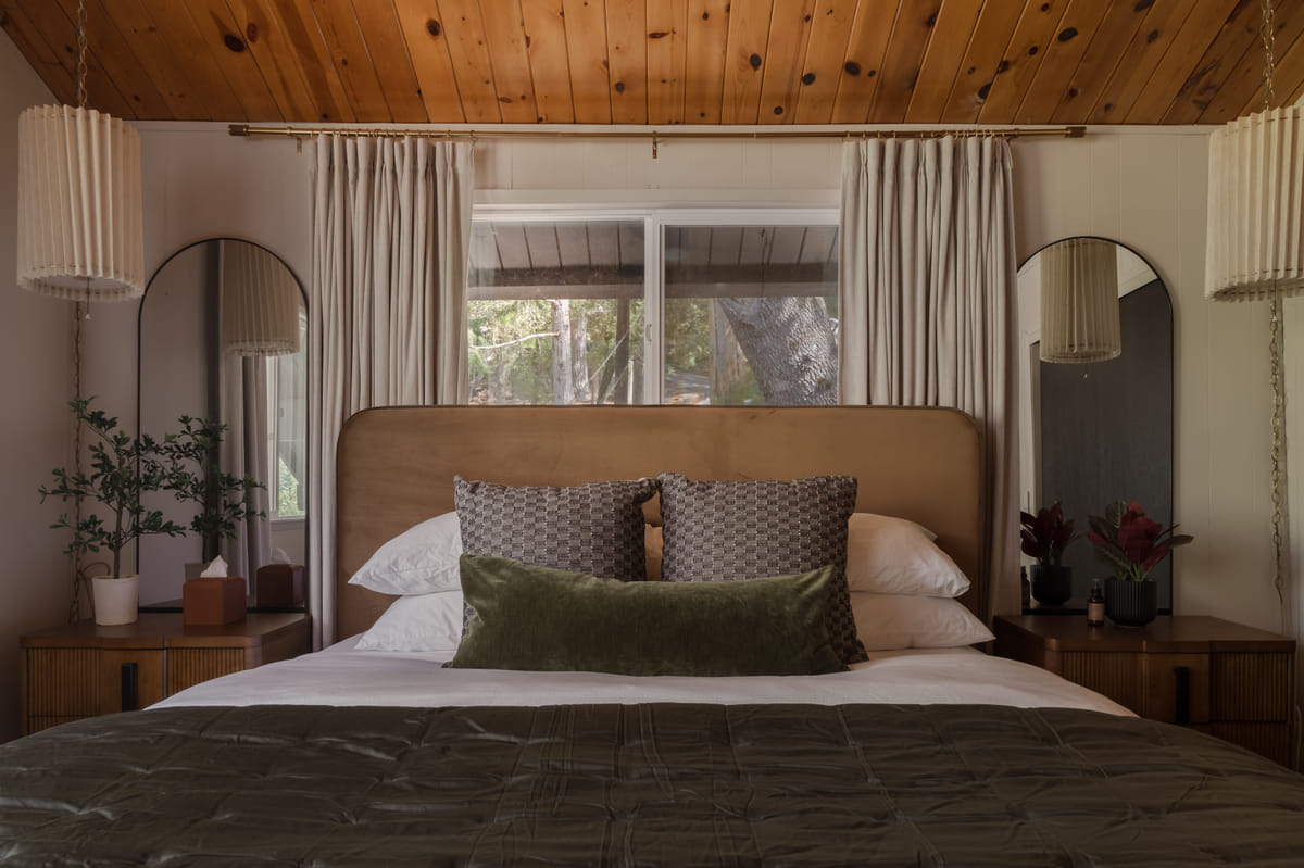 The upstairs bedroom, a king bed with arched mirrors