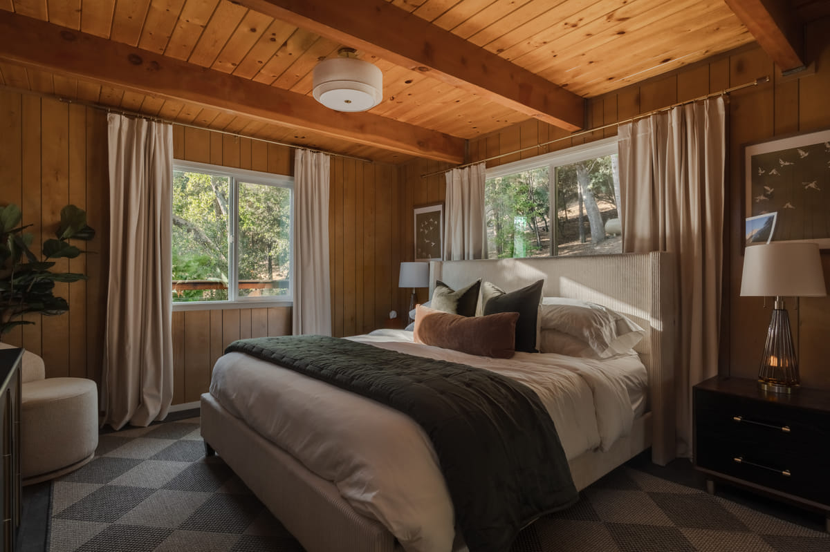 The primary bedroom, a king bed under the beams